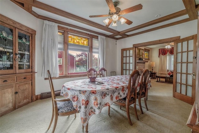 dining area featuring light colored carpet, ceiling fan, coffered ceiling, french doors, and beamed ceiling