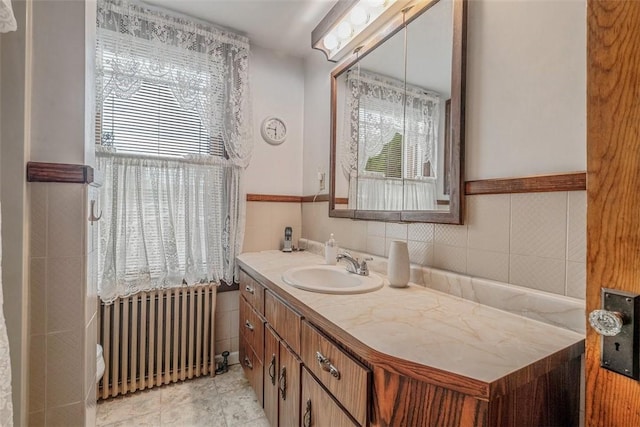 bathroom with radiator, plenty of natural light, and vanity
