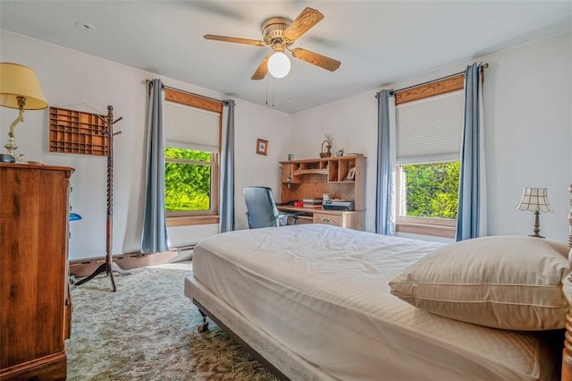 bedroom with multiple windows and ceiling fan