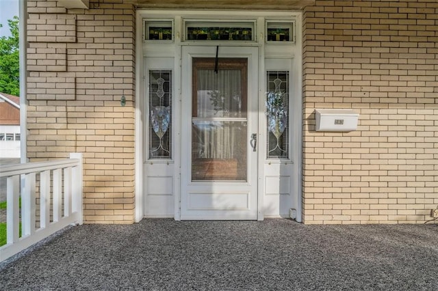 doorway to property with brick siding