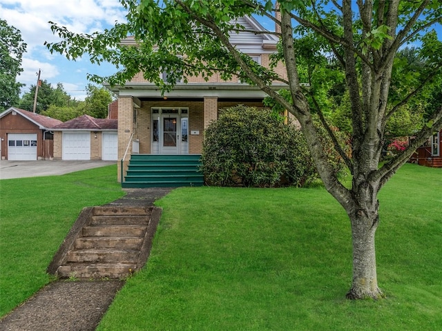 view of front facade featuring brick siding, a porch, a front yard, and driveway