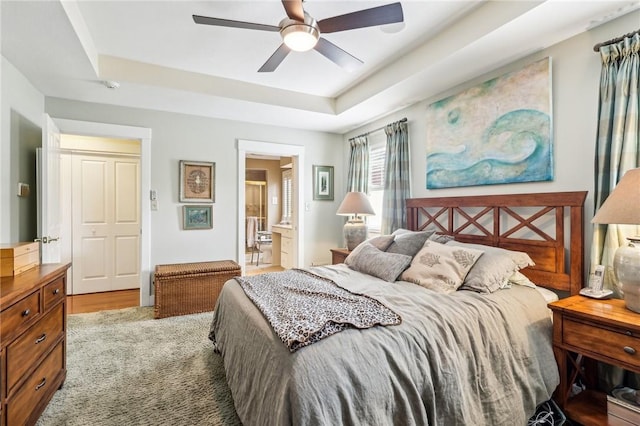 238 Berkeley Way, Monroeville, PA 15146 - bedroom featuring a tray ceiling, connected bathroom, and ceiling fan