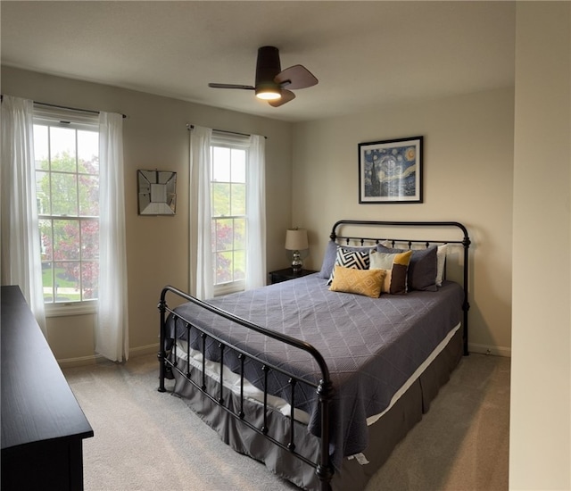 bedroom featuring carpet, baseboards, and ceiling fan
