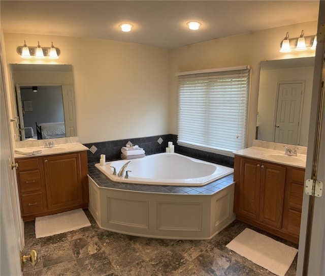 ensuite bathroom featuring two vanities and a garden tub