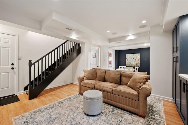 living room with stairway, light wood-style floors, recessed lighting, and baseboards