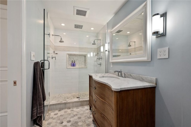 full bath with a stall shower, vanity, and recessed lighting