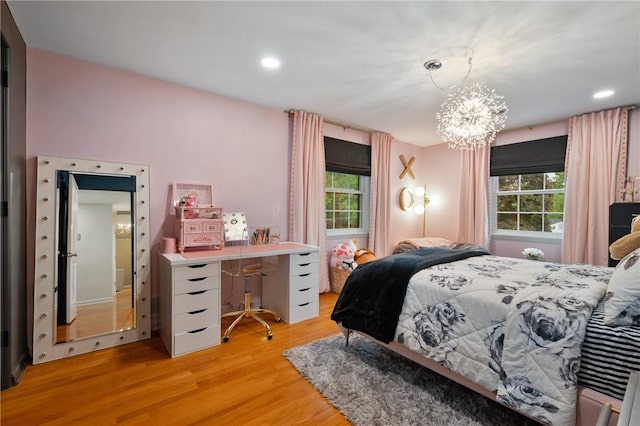 bedroom with multiple windows, light wood-style floors, a chandelier, and recessed lighting