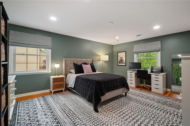 bedroom featuring wood finished floors, a desk, recessed lighting, and baseboards