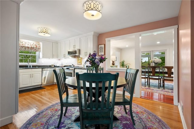 dining area with light wood-style floors