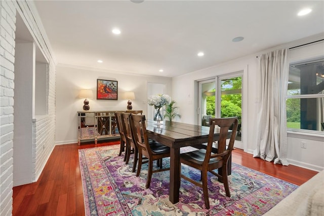 dining room with hardwood / wood-style floors, baseboards, and recessed lighting