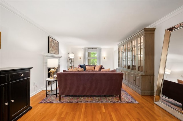 living room with light wood-type flooring and ornamental molding