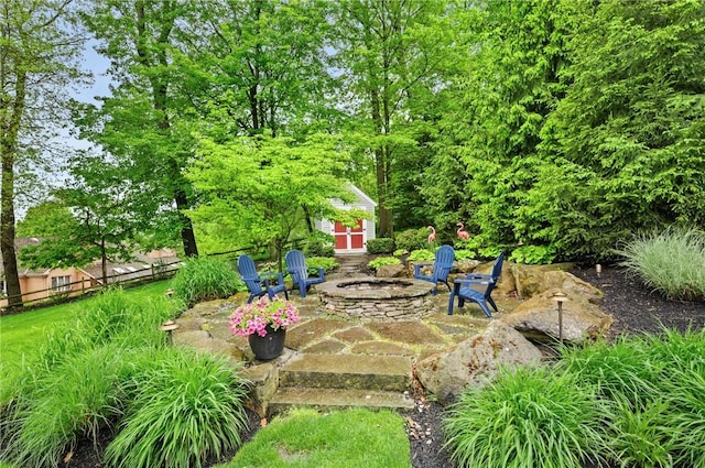 view of yard with a fire pit, an outbuilding, and a patio