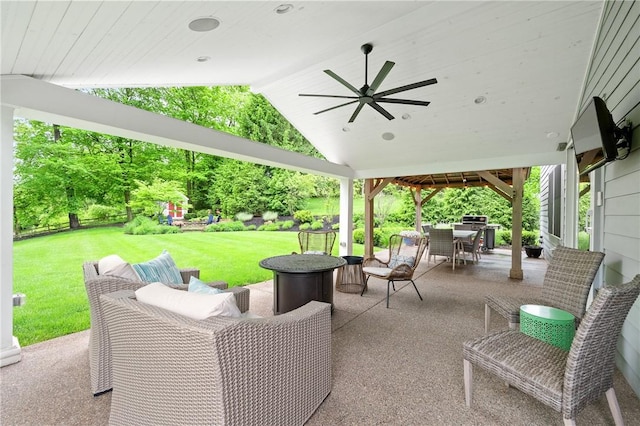 view of patio with outdoor dining area, ceiling fan, a gazebo, an outdoor living space, and a playground