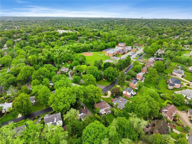 aerial perspective of suburban area with a heavily wooded area