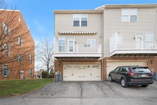 3009 Village Run, Pine Twp Nal, PA 15090 - view of front facade featuring asphalt driveway, an attached garage, brick siding, a balcony, and cooling unit