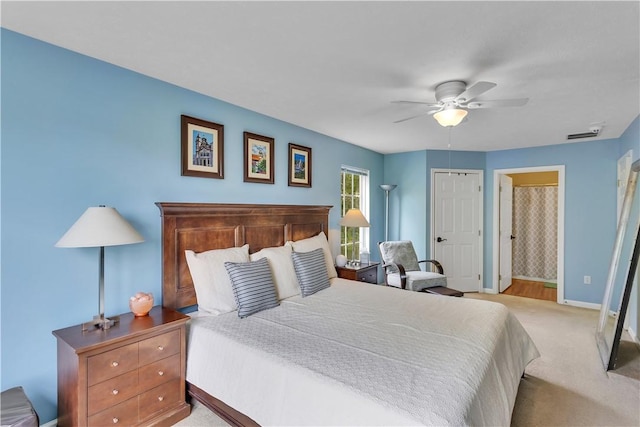 bedroom featuring baseboards, light carpet, and ceiling fan