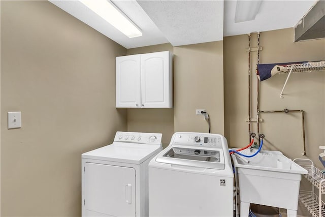 washroom with washer and clothes dryer and cabinet space