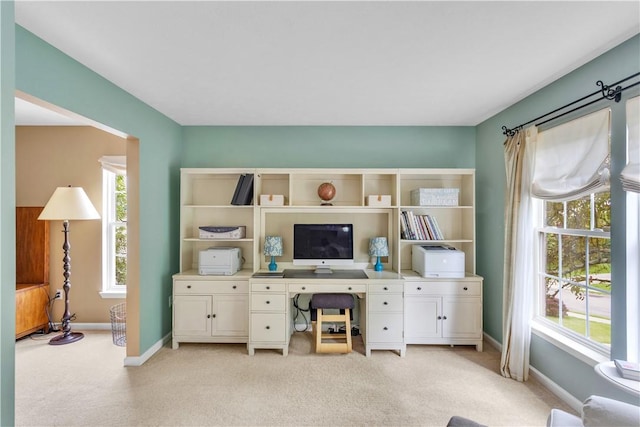 office featuring light carpet and baseboards