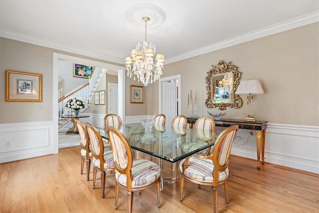 305 Woodstream Dr, Ohara, PA 15238 - dining space with a chandelier, stairs, light wood finished floors, a wainscoted wall, and crown molding