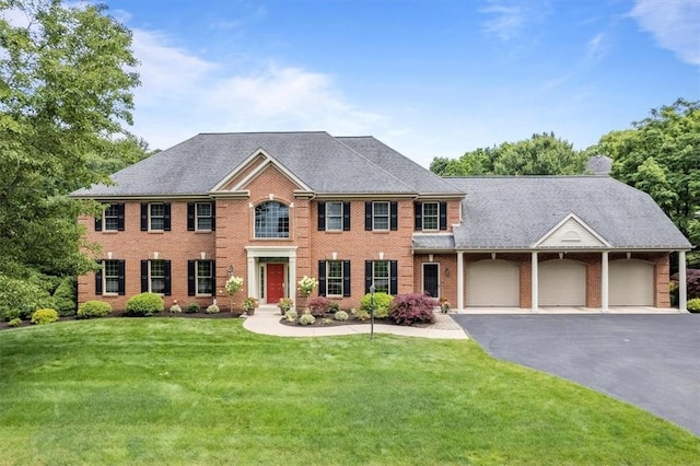 305 Woodstream Dr, Ohara, PA 15238 - colonial home featuring an attached garage, driveway, a front yard, and brick siding