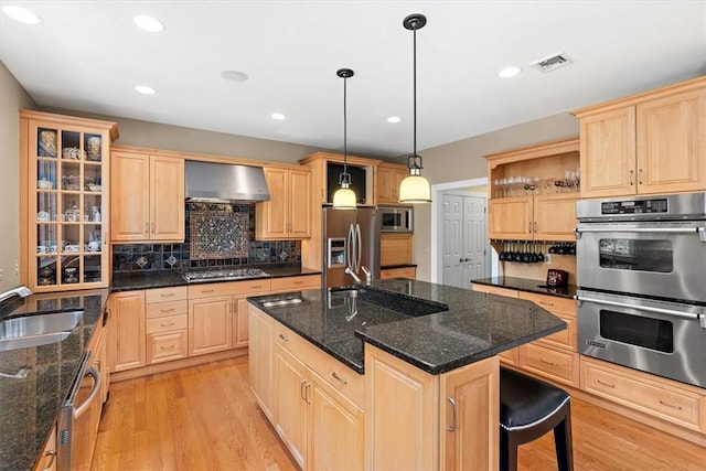 305 Woodstream Dr, Ohara, PA 15238 - kitchen with appliances with stainless steel finishes, light brown cabinetry, wall chimney exhaust hood, a sink, and recessed lighting