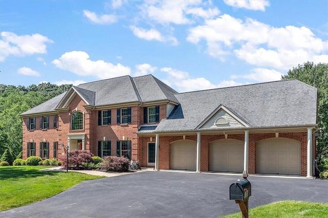 305 Woodstream Dr, Ohara, PA 15238 - view of front of home with asphalt driveway, an attached garage, brick siding, and a front lawn