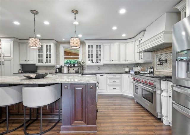 432 Independence Blvd, South Strabane, PA 15301 - kitchen featuring appliances with stainless steel finishes, custom range hood, decorative backsplash, glass insert cabinets, and recessed lighting