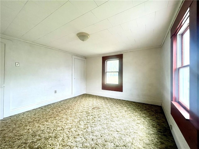 carpeted spare room with baseboards