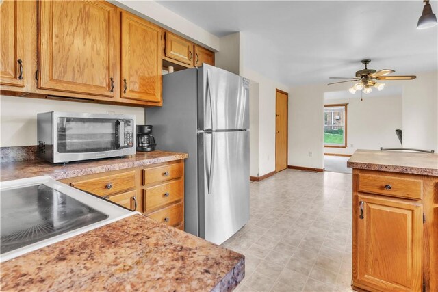 1636 Brodhead Rd, Moon/Crescent Twp, PA 15108 - kitchen featuring appliances with stainless steel finishes, ceiling fan, light countertops, a sink, and brown cabinetry