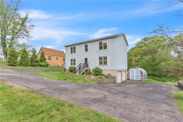 1636 Brodhead Rd, Moon/Crescent Twp, PA 15108 - colonial inspired home featuring a storage shed, driveway, an attached garage, an outdoor structure, and a front yard