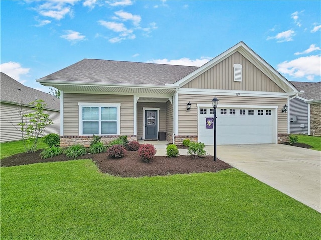 129 Bay Ct, Chartiers, PA 15301 - view of front of house with concrete driveway, a front yard, a garage, board and batten siding, and stone siding