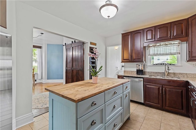 106 Haldane St, Crafton, PA 15205 - kitchen with dishwasher, a sink, wooden counters, a barn door, and light tile patterned floors