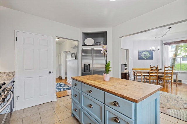 106 Haldane St, Crafton, PA 15205 - kitchen featuring stainless steel appliances, wooden counters, a chandelier, light tile patterned floors, and gray cabinets