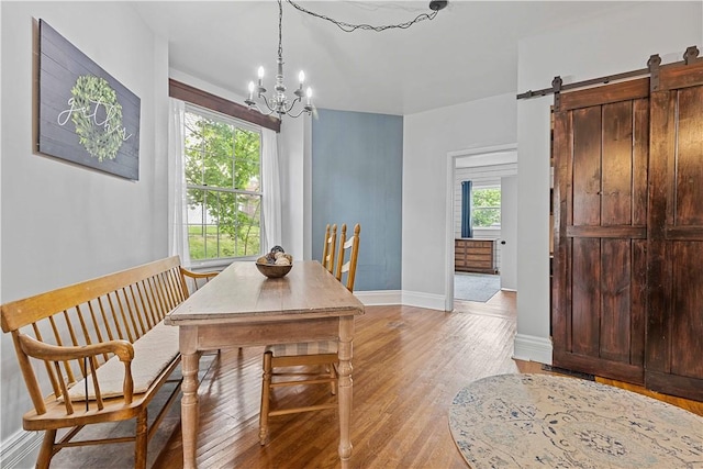 106 Haldane St, Crafton, PA 15205 - dining area featuring light wood-type flooring, a chandelier, baseboards, and a barn door