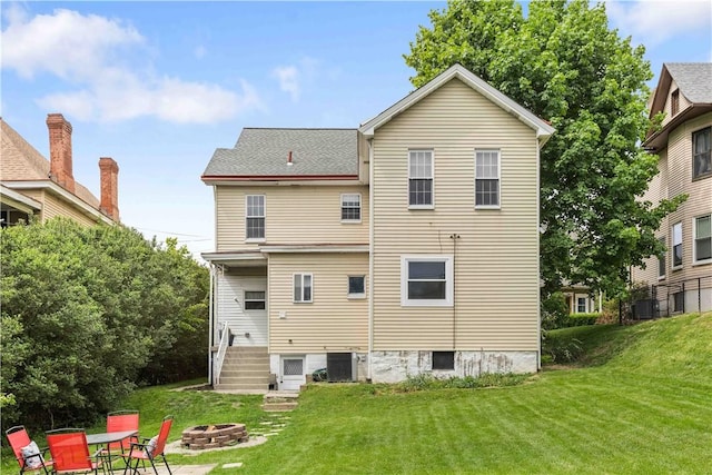106 Haldane St, Crafton, PA 15205 - back of house featuring a fire pit, a lawn, central air condition unit, and roof with shingles