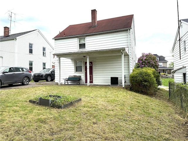 back of house with a chimney