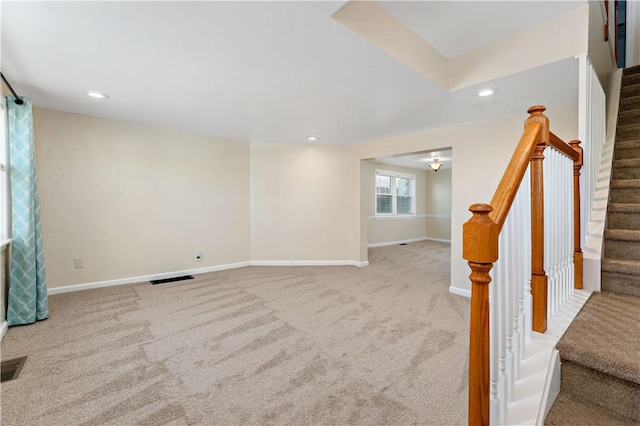 carpeted spare room with baseboards, stairs, and recessed lighting