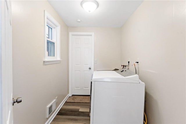 laundry room with independent washer and dryer, wood finished floors, and baseboards
