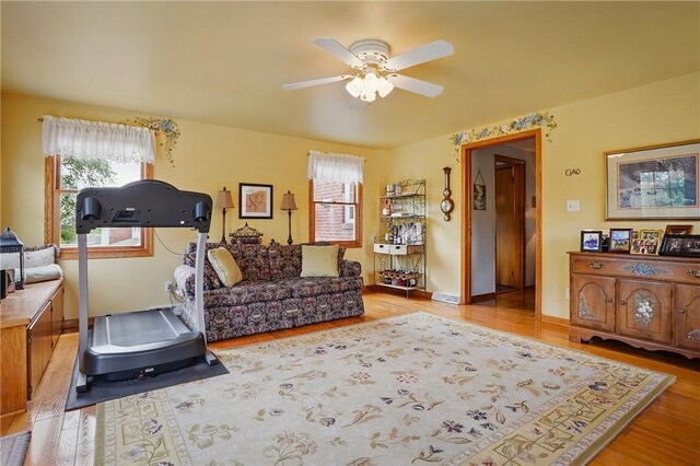exercise room featuring a ceiling fan and wood finished floors