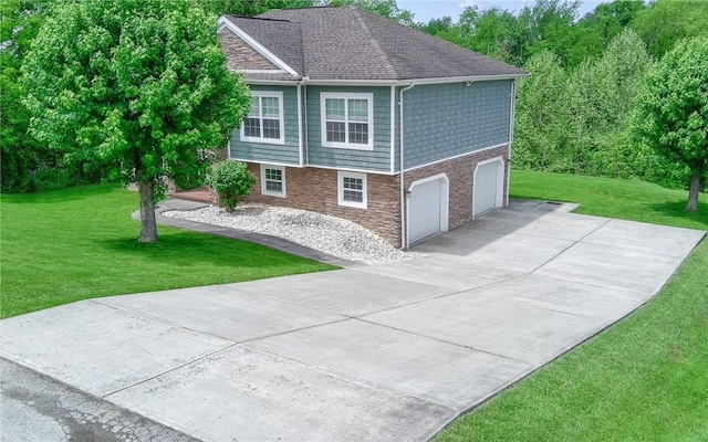 view of side of property with stone siding, concrete driveway, a yard, and an attached garage