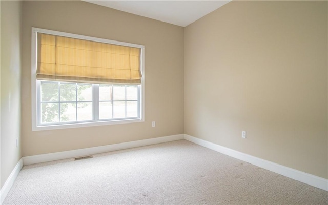 spare room with carpet flooring and baseboards