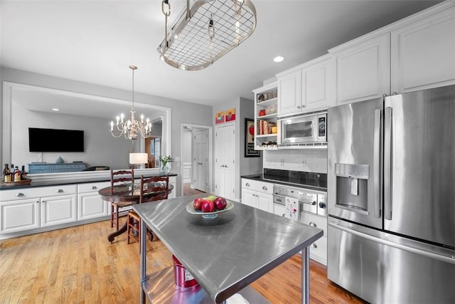 kitchen featuring stainless steel appliances, white cabinetry, dark countertops, open shelves, and recessed lighting