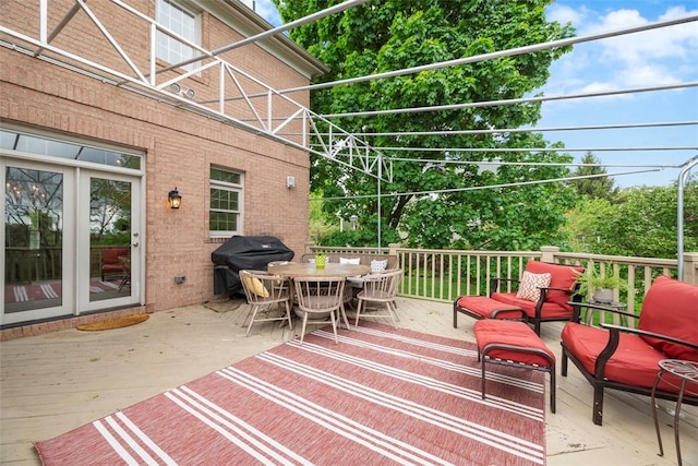 deck featuring area for grilling and outdoor dining area