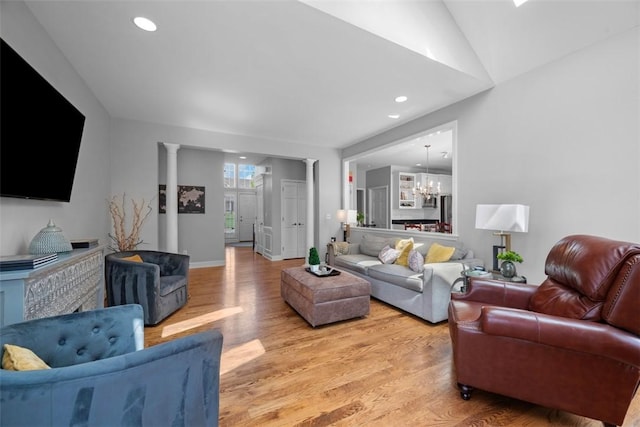 living room with light wood-type flooring, a chandelier, and recessed lighting
