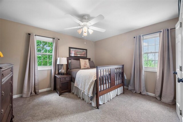 bedroom with baseboards, light colored carpet, and ceiling fan