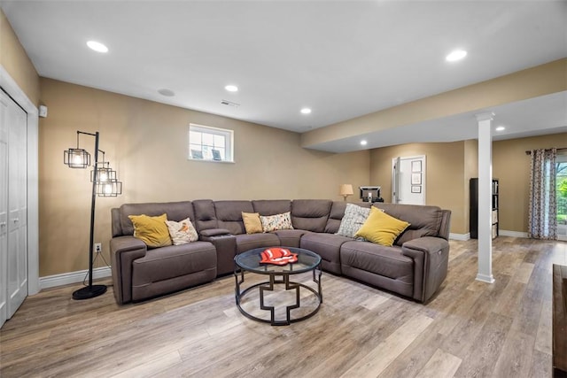 living area featuring light wood finished floors, baseboards, recessed lighting, and healthy amount of natural light