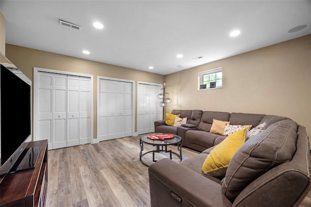 living room featuring light wood-type flooring and recessed lighting