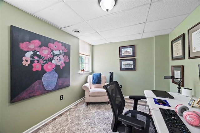 office with a paneled ceiling and baseboards