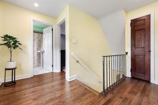 stairs featuring wood finished floors and baseboards