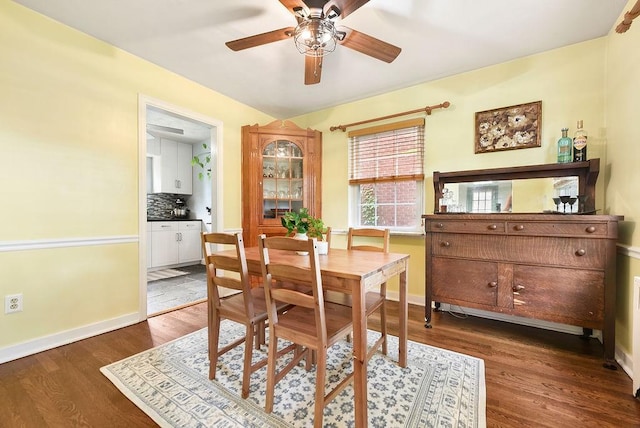 dining area with ceiling fan, wood finished floors, and baseboards